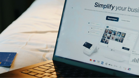Renter completing a booking on a laptop with a payment card at hand