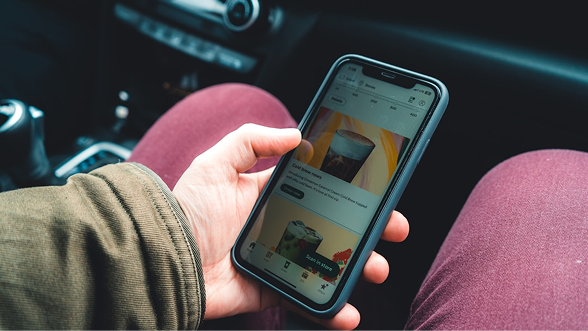 Renter browsing AUFFO car listings on a phone